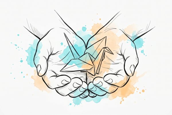 Pen-and-ink illustration of cupped open hands gently sheltering a small origami paper bird, with soft cyan and apricot watercolour splashes — a symbol of self-kindness and quieting the inner critic